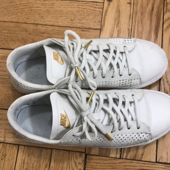 white sneakers with gold accents